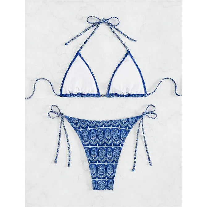 Women's green split bikini bandage swimsuit with printed stitching on a model