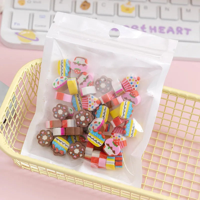 Open pearlescent film bag showing 50 small colourful cartoon fruit-themed rubber erasers.