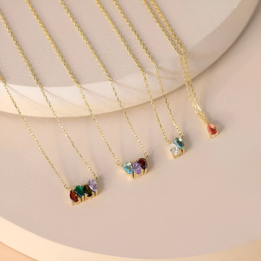 Close-up of a zircon stone birth month pendant on a titanium steel clavicle chain in rose gold finish.