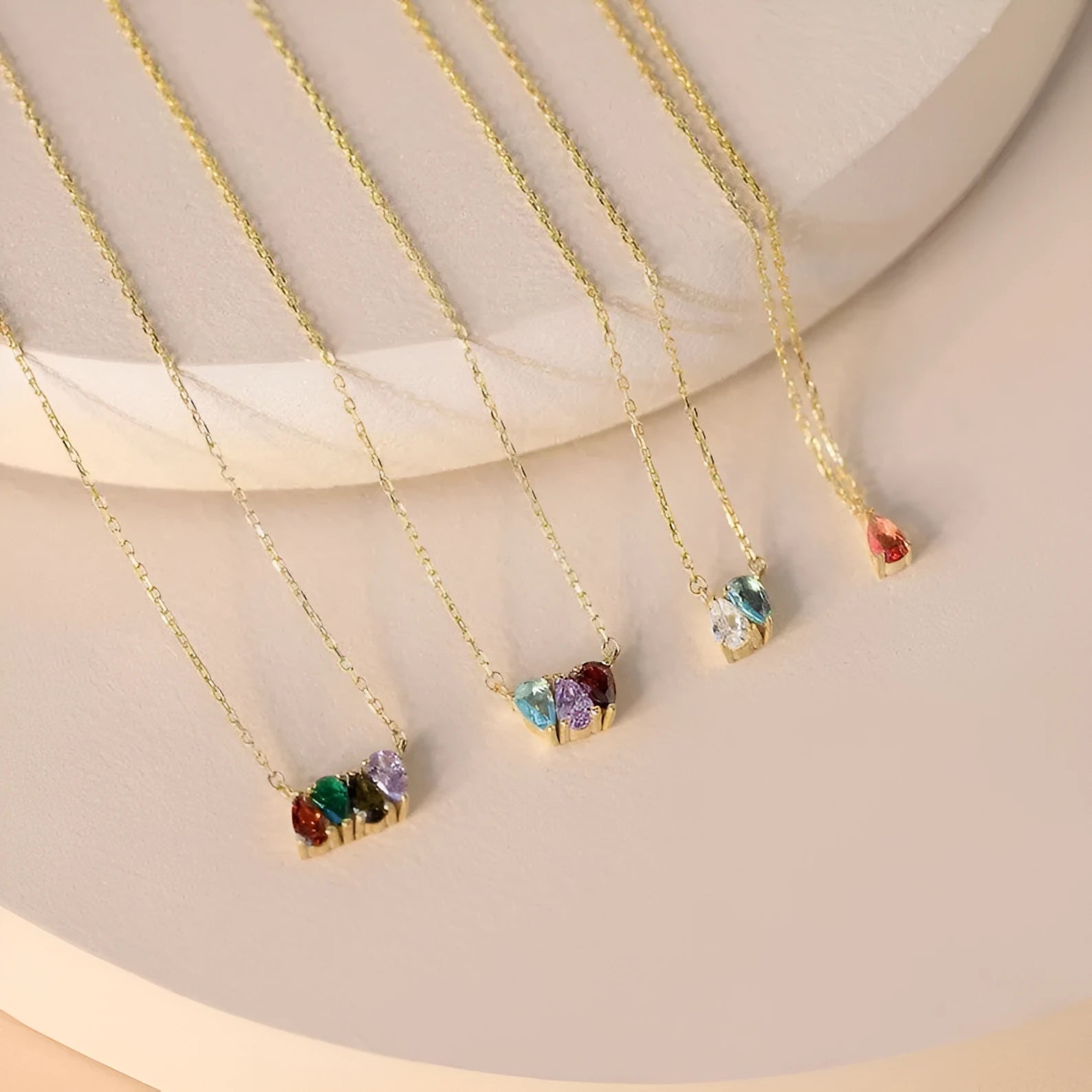 Close-up of a zircon stone birth month pendant on a titanium steel clavicle chain in rose gold finish.