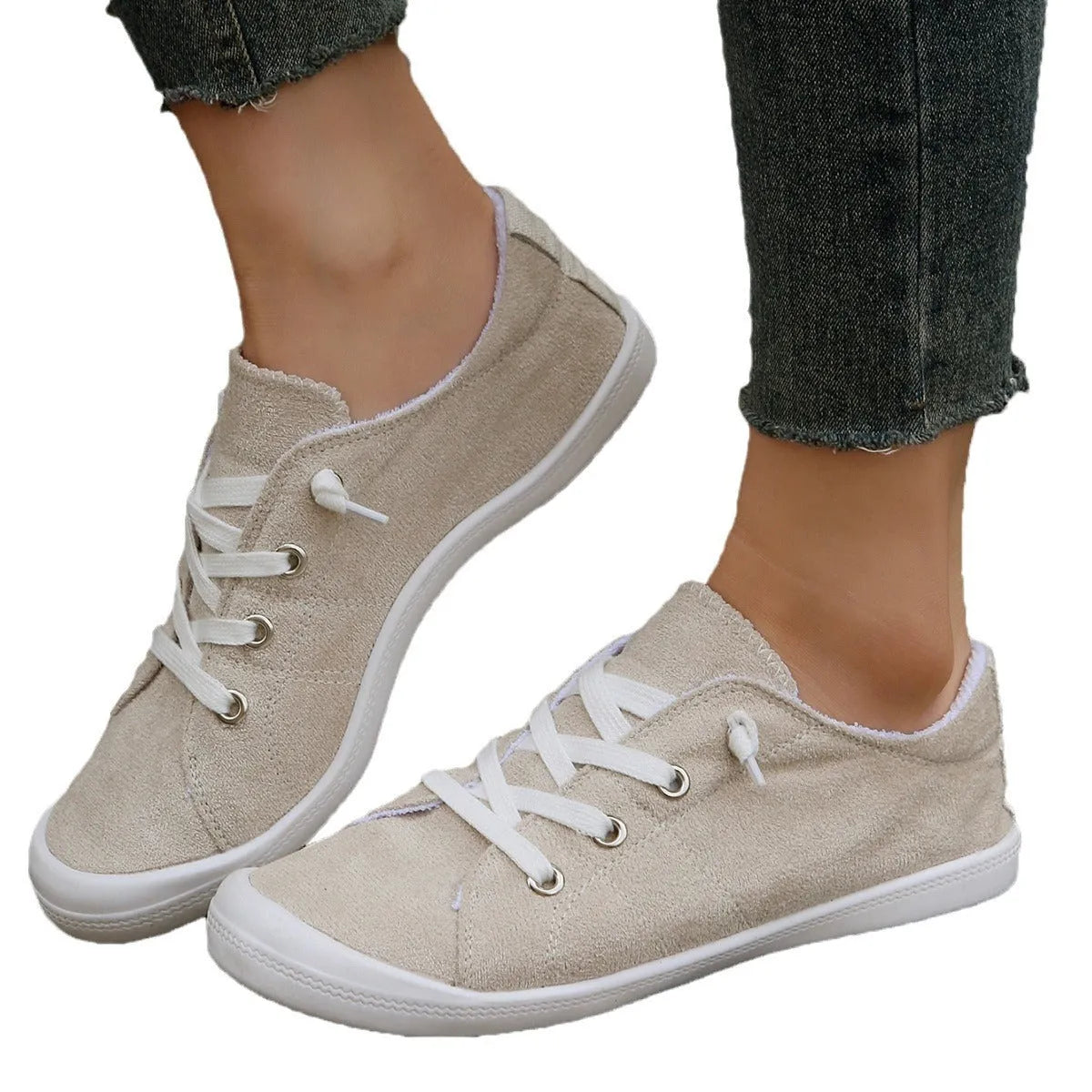 Creamy-white women's low-top fabric casual sneakers with a rubber sole.