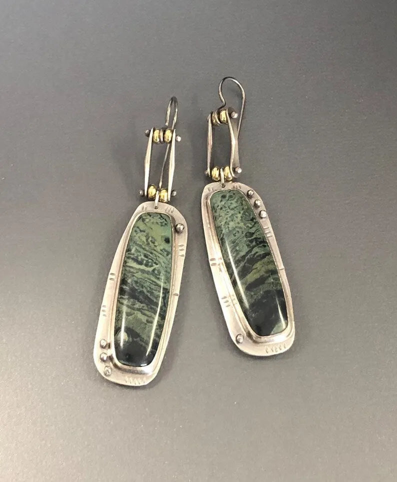 Two-colour marble pattern geometric alloy drop earrings on a white background.