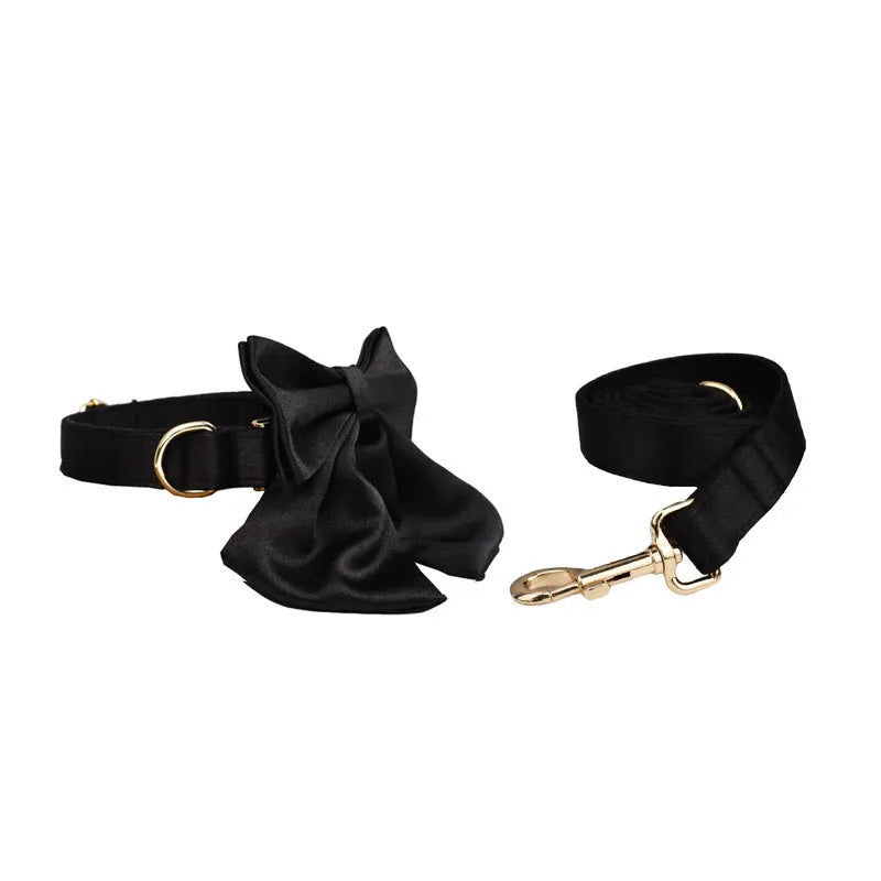 Dog wearing cloth chest strap harness with matching collar, leash, and decorative bow tie