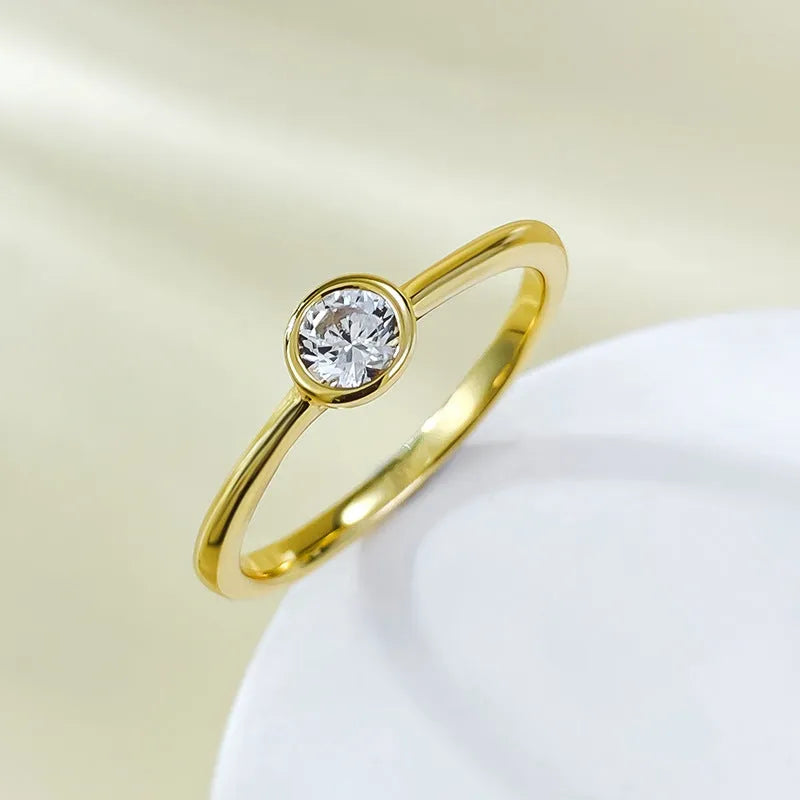 Minimalist silver crown-shaped ring with linear details, shown in gold and platinum finishes.
