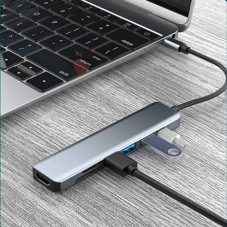 USB-C 7-in-1 hub expander with short cable, showing HDMI, VGA, and USB ports.