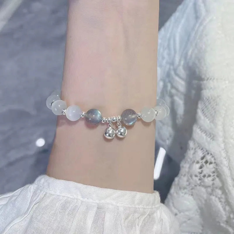 Chinese style handmade glass bead bracelet with bamboo joint elements on a white background.