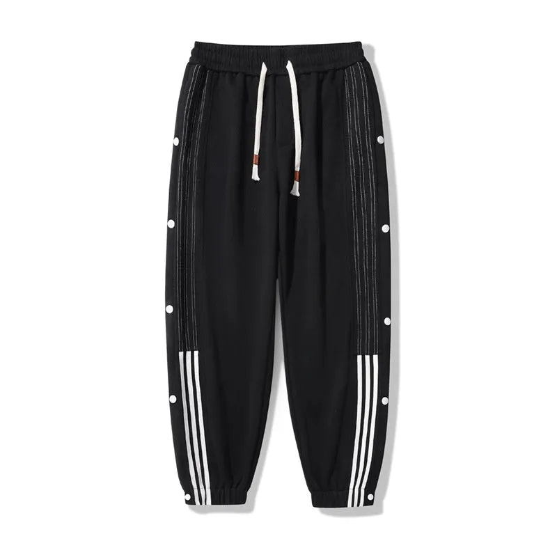Men's loose fit ankle-tied sports pants in black with drawstring waist and elastic cuffs