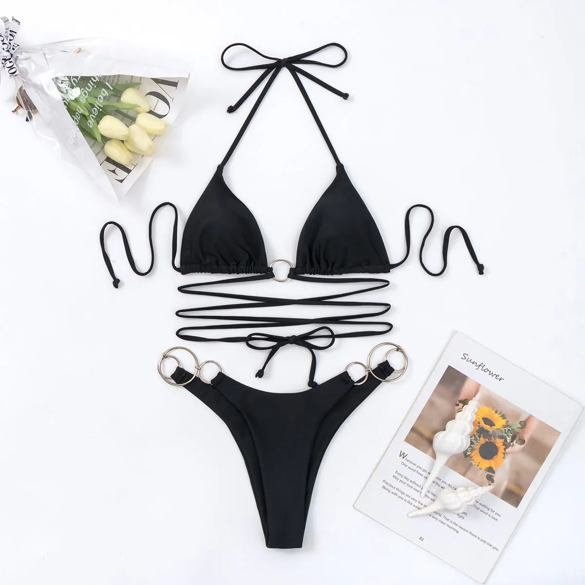 Black women's bikini set with metal rings on the straps and a backless design