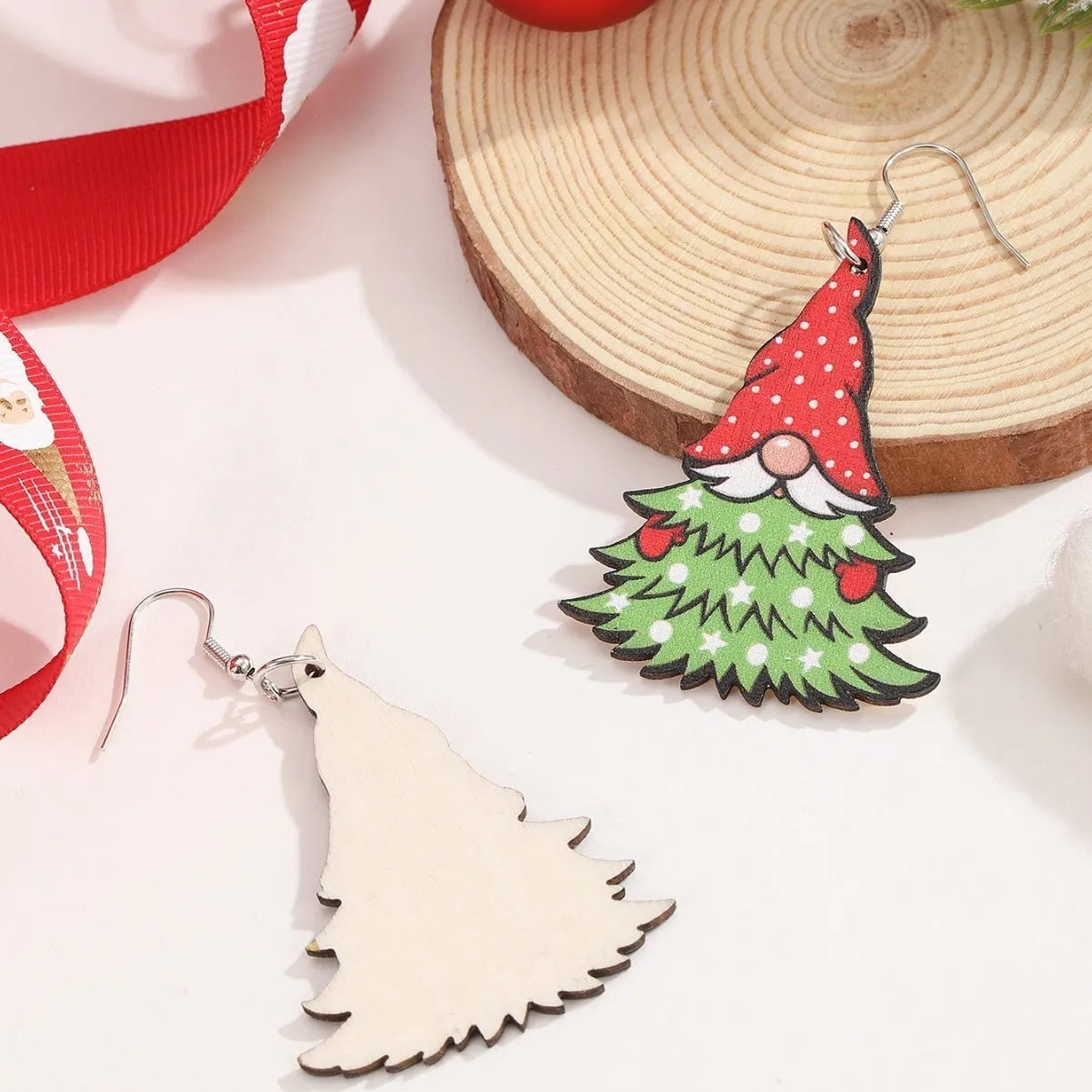 Wooden Christmas earrings with geometric shapes showing printed tree and snowman designs