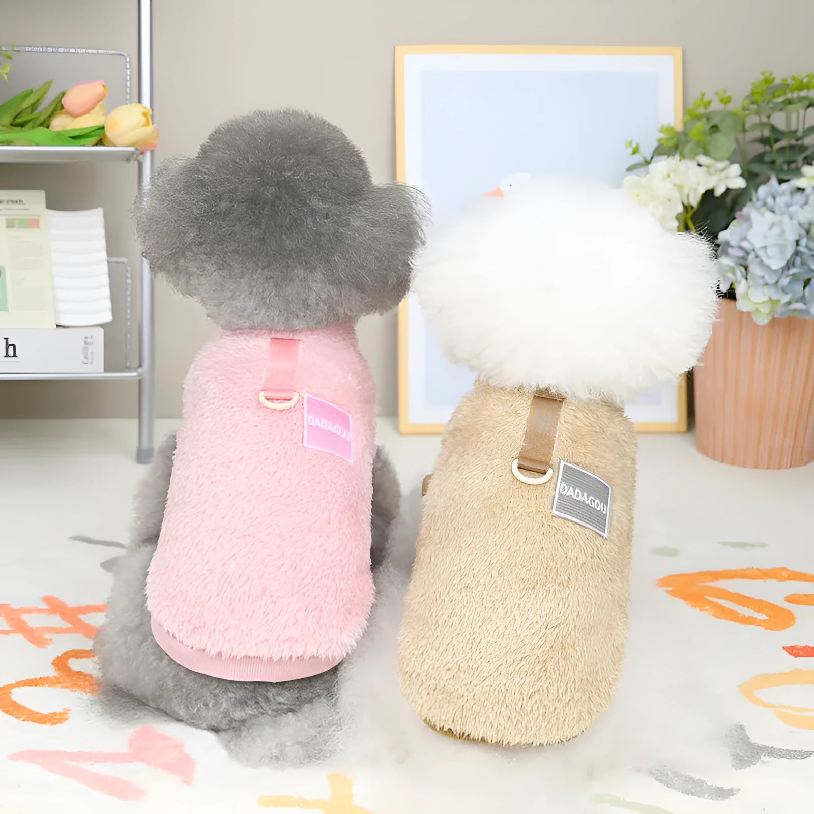 A blue coral fleece pet jacket for dogs or cats fastened with multicoloured pull rings.