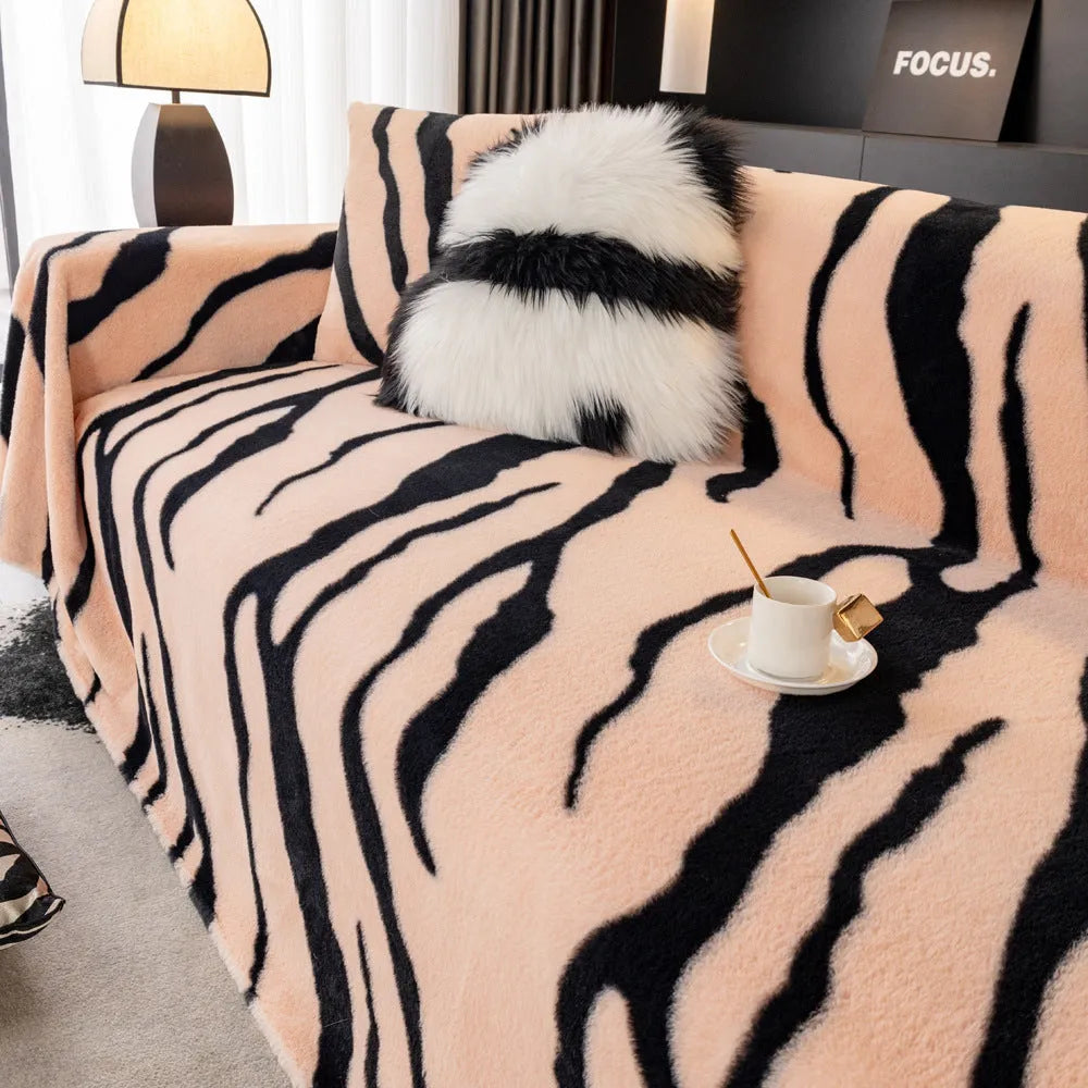 Zebra pattern flannel sofa cover with non-slip properties in caramel colour on a sofa