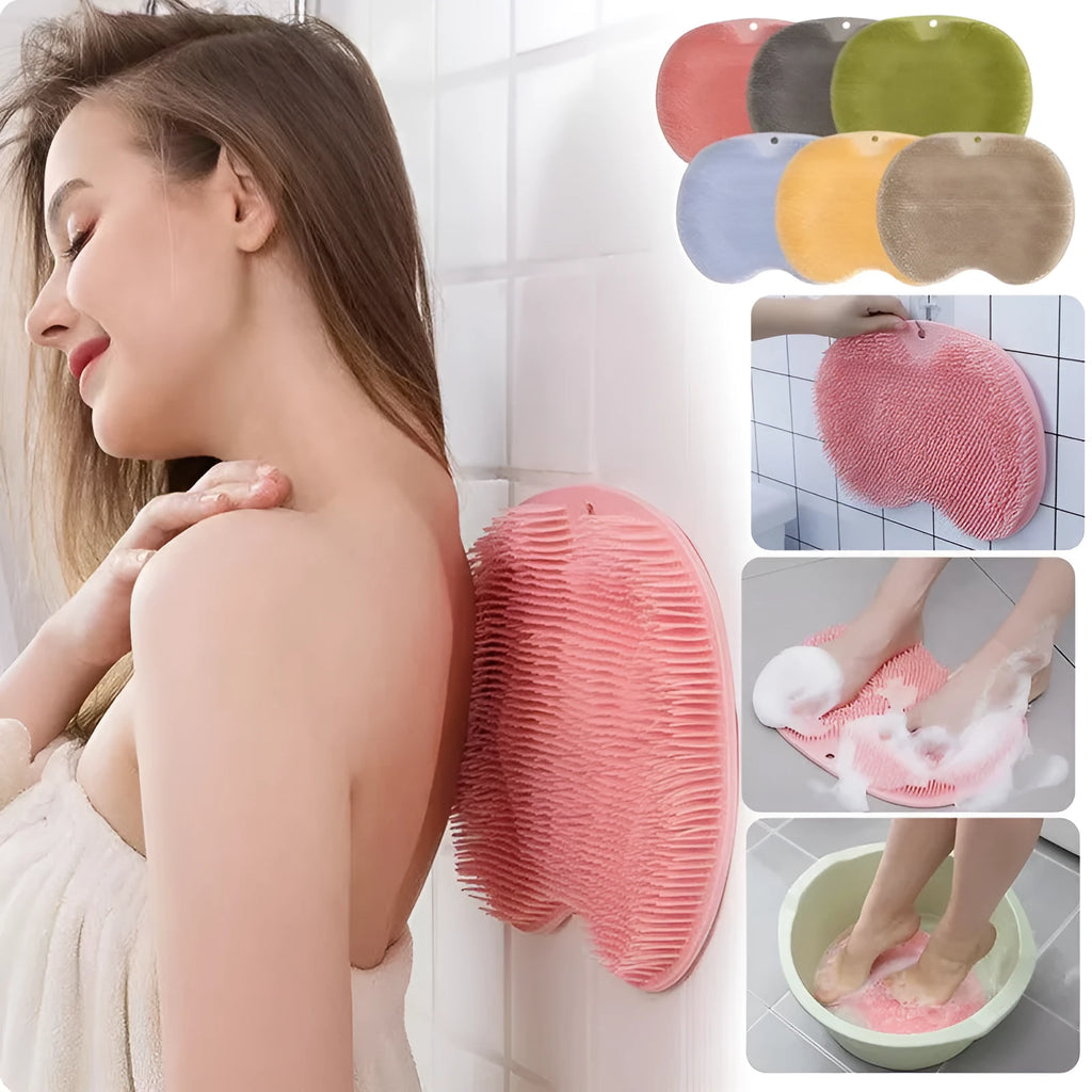 Orange silicone bath massage brush with suction cups on a bathroom tile floor.