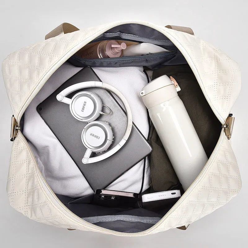 Oxford cloth travel bag in a solid colour with sewing thread detail, shown with 36-55L capacity.