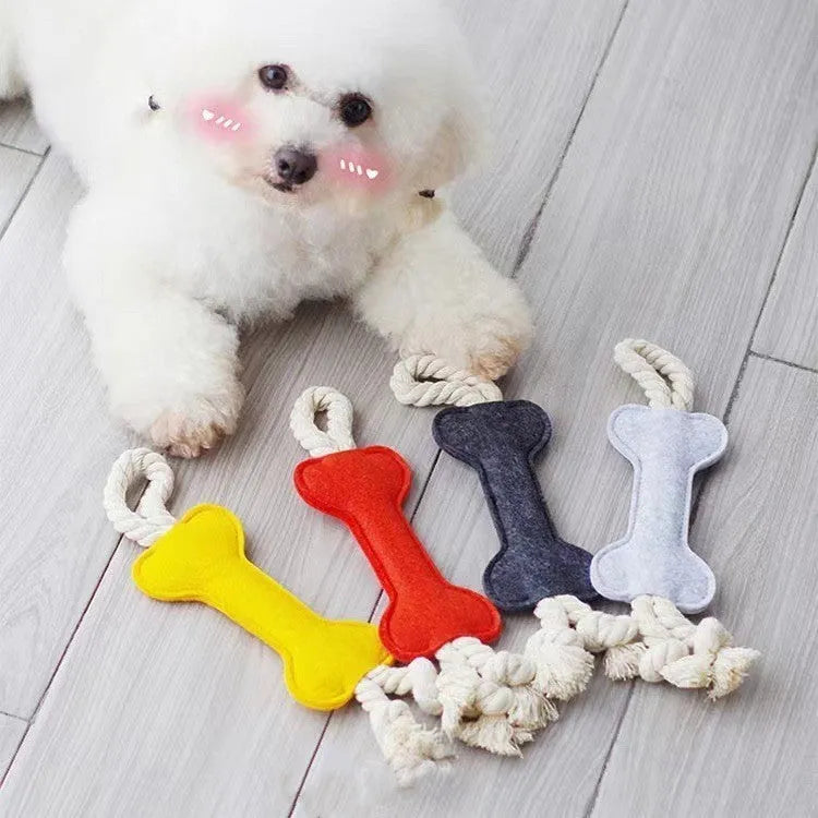 Bone-shaped felt dog chew toy with rope knot interior in blue, shown next to a tape measure indicating 16 cm length.