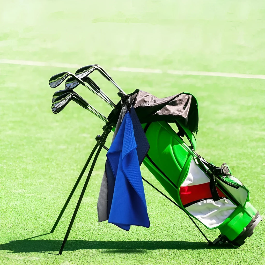Waffle weave golf ball cleaning cloth in selected colour on a green.