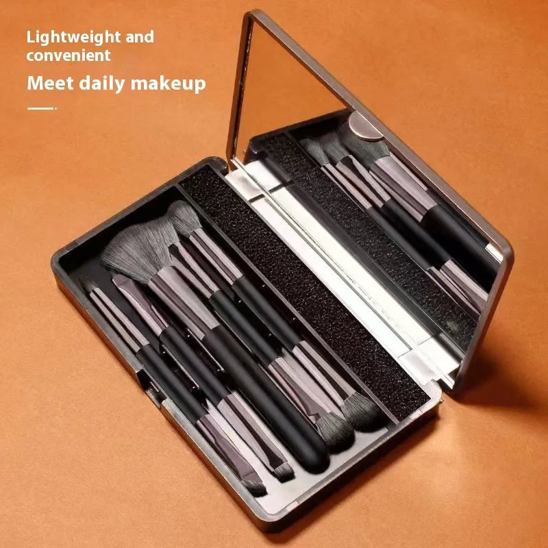 Boxed portable makeup brush set with mirror showing silver, gold, and little sparrow colour options