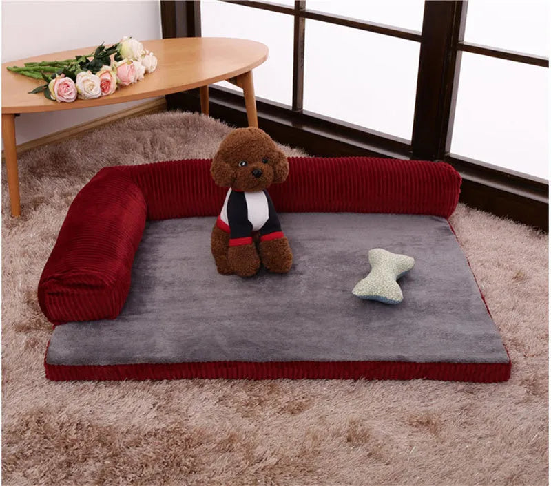 Corduroy dog sofa bed with bolster sides in a grey colour, shown on a wooden floor.