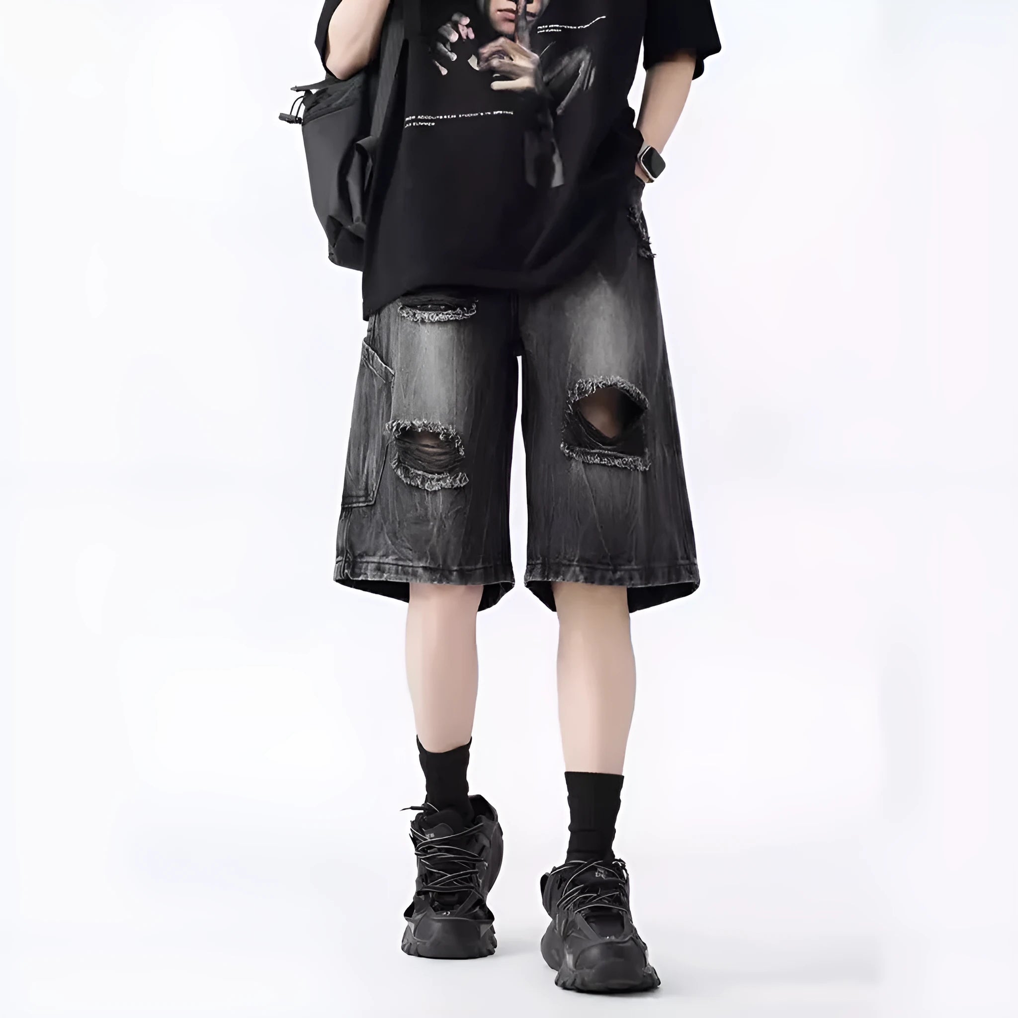 Loose-fit denim shorts with a washed fabric finish and ripped, distressed detailing on the legs.