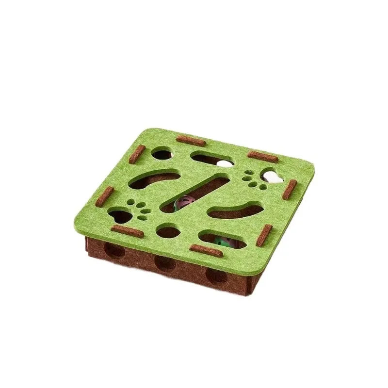 Green brown felt square cat toy with a hole in the centre on a wooden floor.