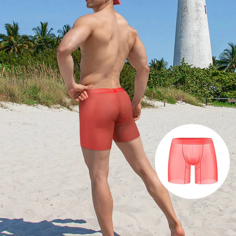 Men's solid colour ice silk boxer shorts in orange, showing low waist design.