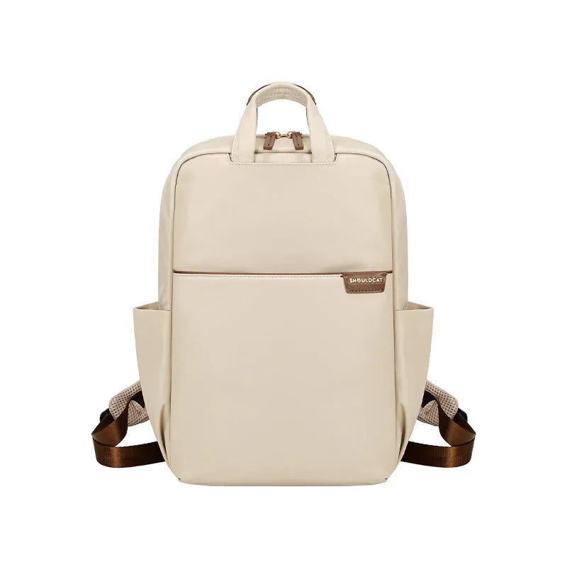 Large canvas women's backpack in apricot colour showing front view with multiple pockets and internal compartments open.