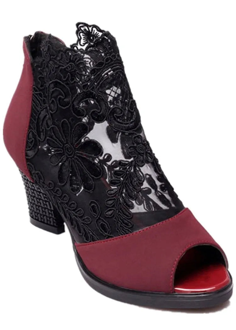Black women's gladiator sandals with floral lace upper, square high heel, peep toe, and zip closure.