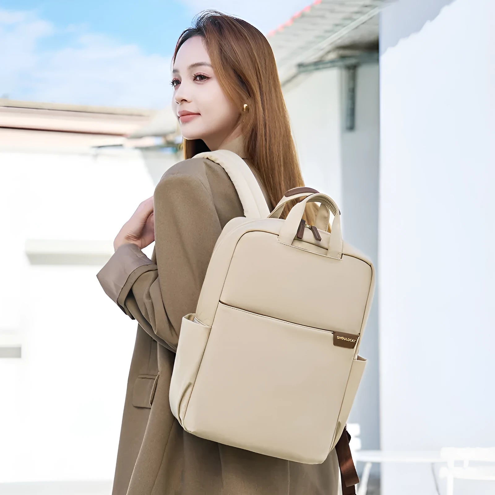 Large canvas women's backpack in apricot colour showing front view with multiple pockets and internal compartments open.
