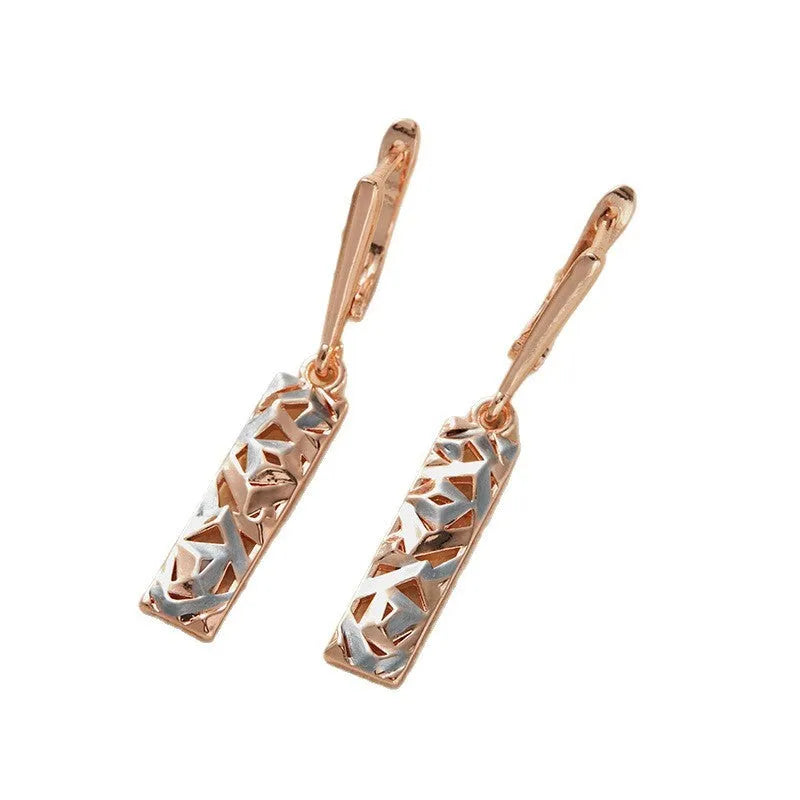 A pair of women's rectangular hollow stud earrings with a two-tone metal finish.