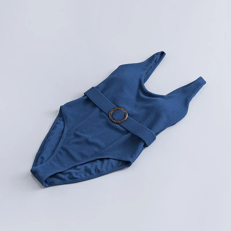 Navy blue women's one-piece swimsuit with slimming triangle design and chest pads