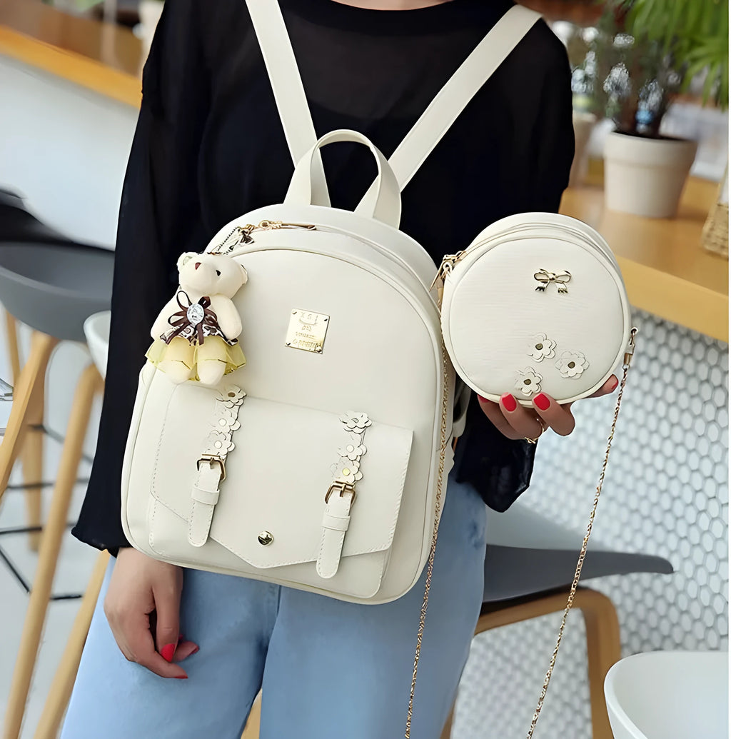 Women's three-piece leather backpack set with floral design including main backpack, shoulder bag, and card holder