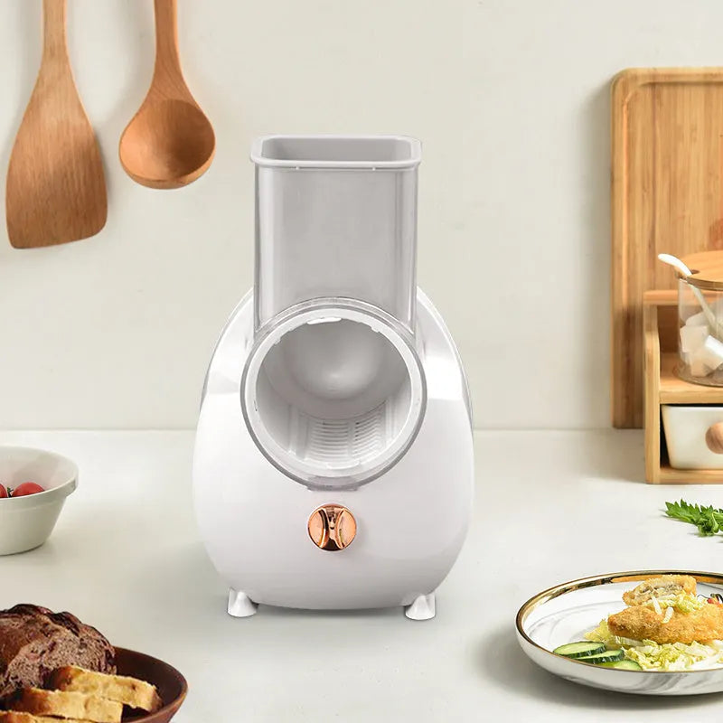 White electric vegetable slicer with rotary grater system and suction base on kitchen counter