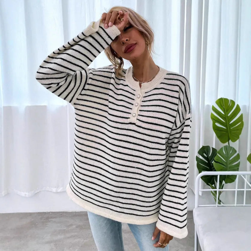 Black striped women's casual top with drop-shoulder sleeves on hanger