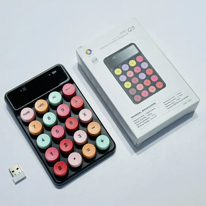Mini portable wireless keyboard in macaron mixed colours on a desk.