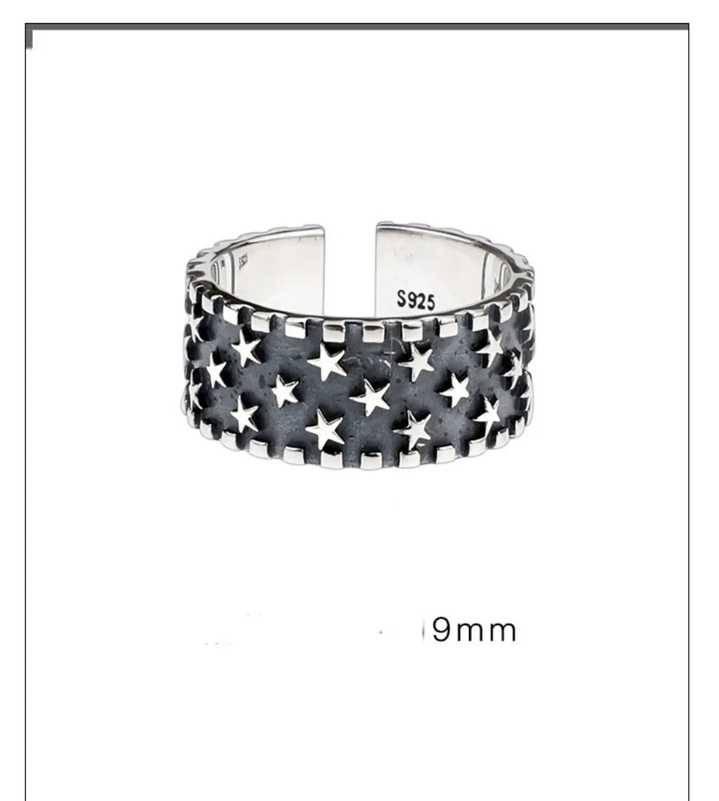 Adjustable open-ended sterling silver ring with a five-pointed star design.