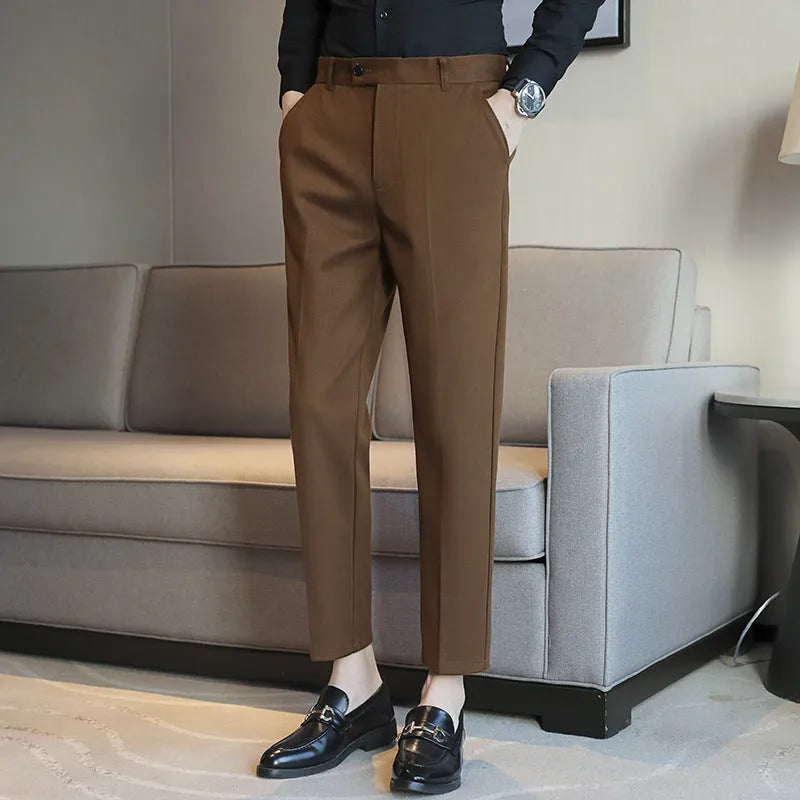 Brown straight leg corduroy trousers with elastic waistband on hanger
