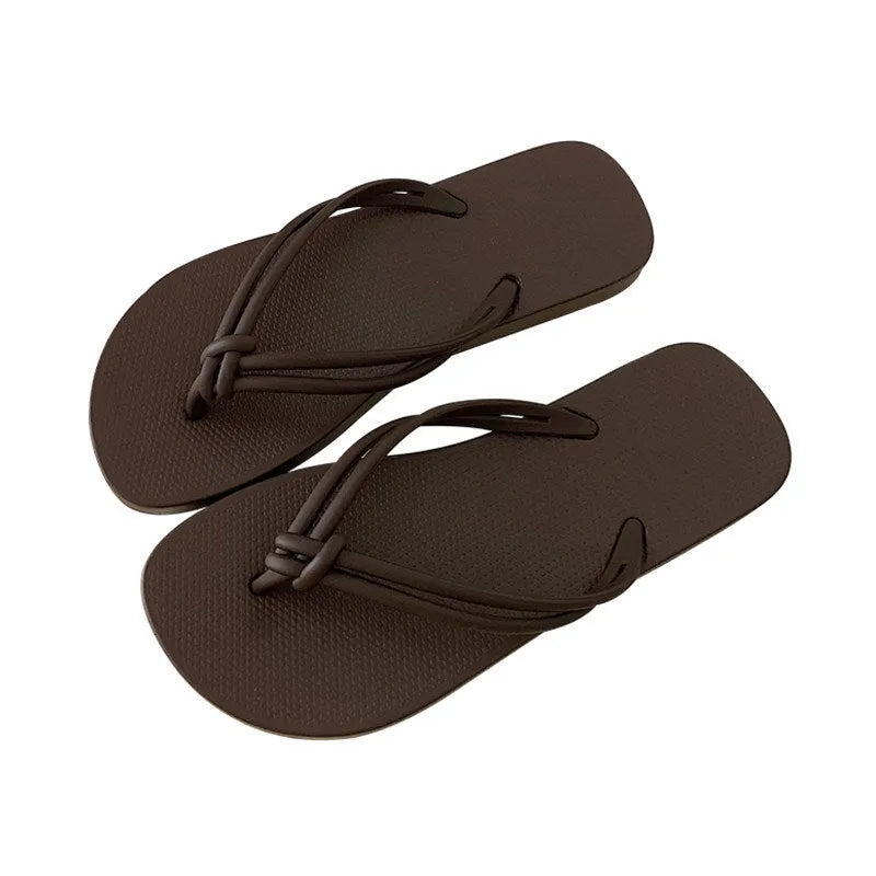 Women's pink PVC closed-toe flip flops with a non-slip sole on a plain background.
