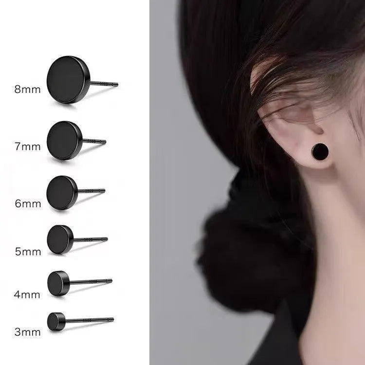 A pair of round, flat S999 sterling silver bone stud earrings on a plain background.