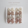 Children's dovetail bow hairclips in eight colour patterns including grid dots and floral designs