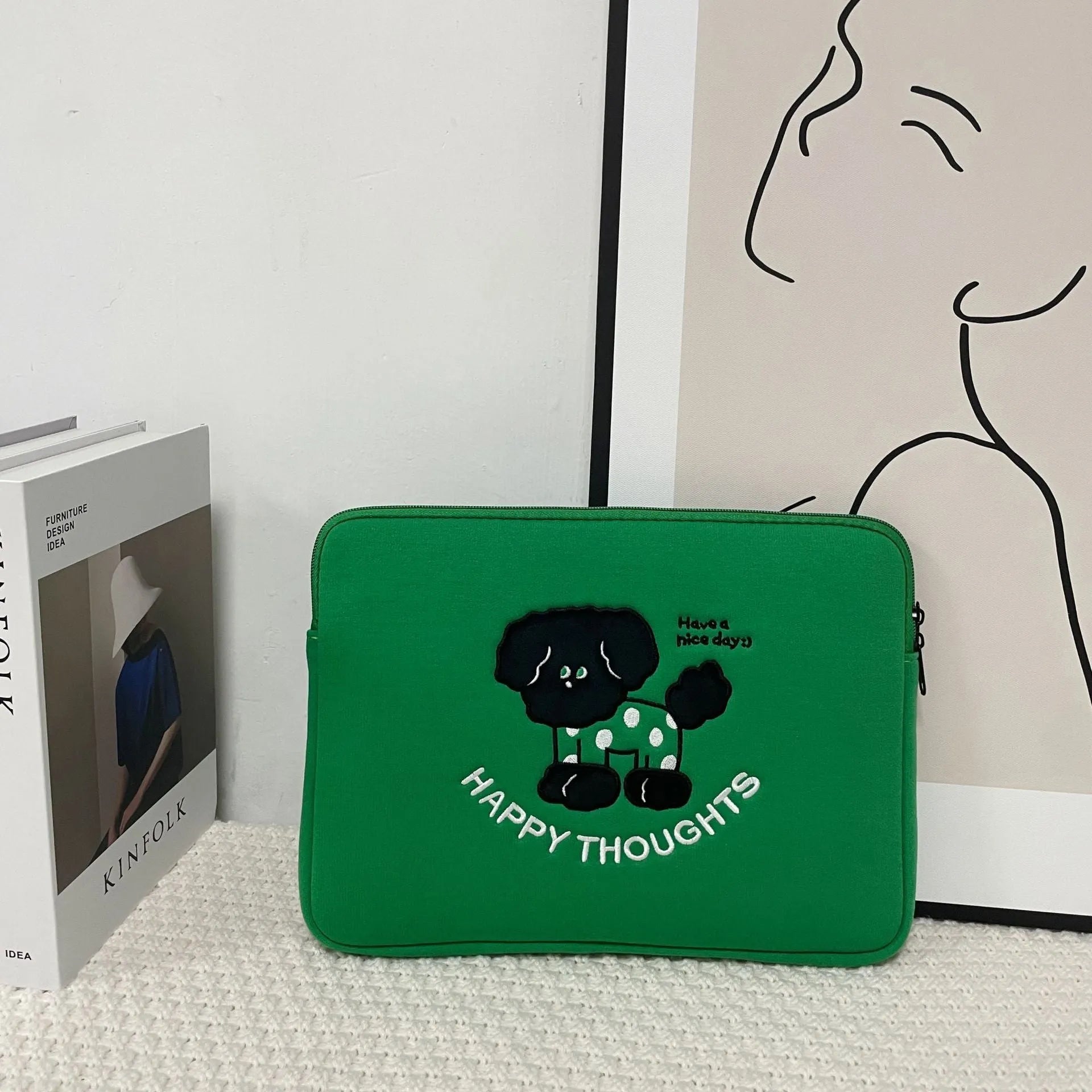 Embroidered laptop sleeve with animal design showing polyester construction and laptop size compatibility