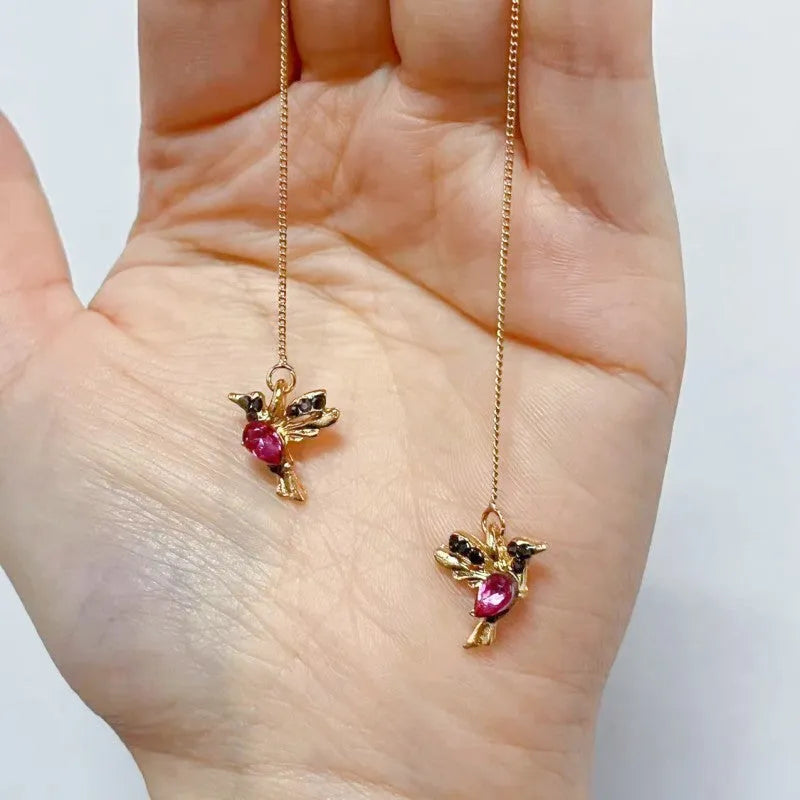 Women's long drop earrings with hanging bird pendants and zirconium crystal accents in blue colour option