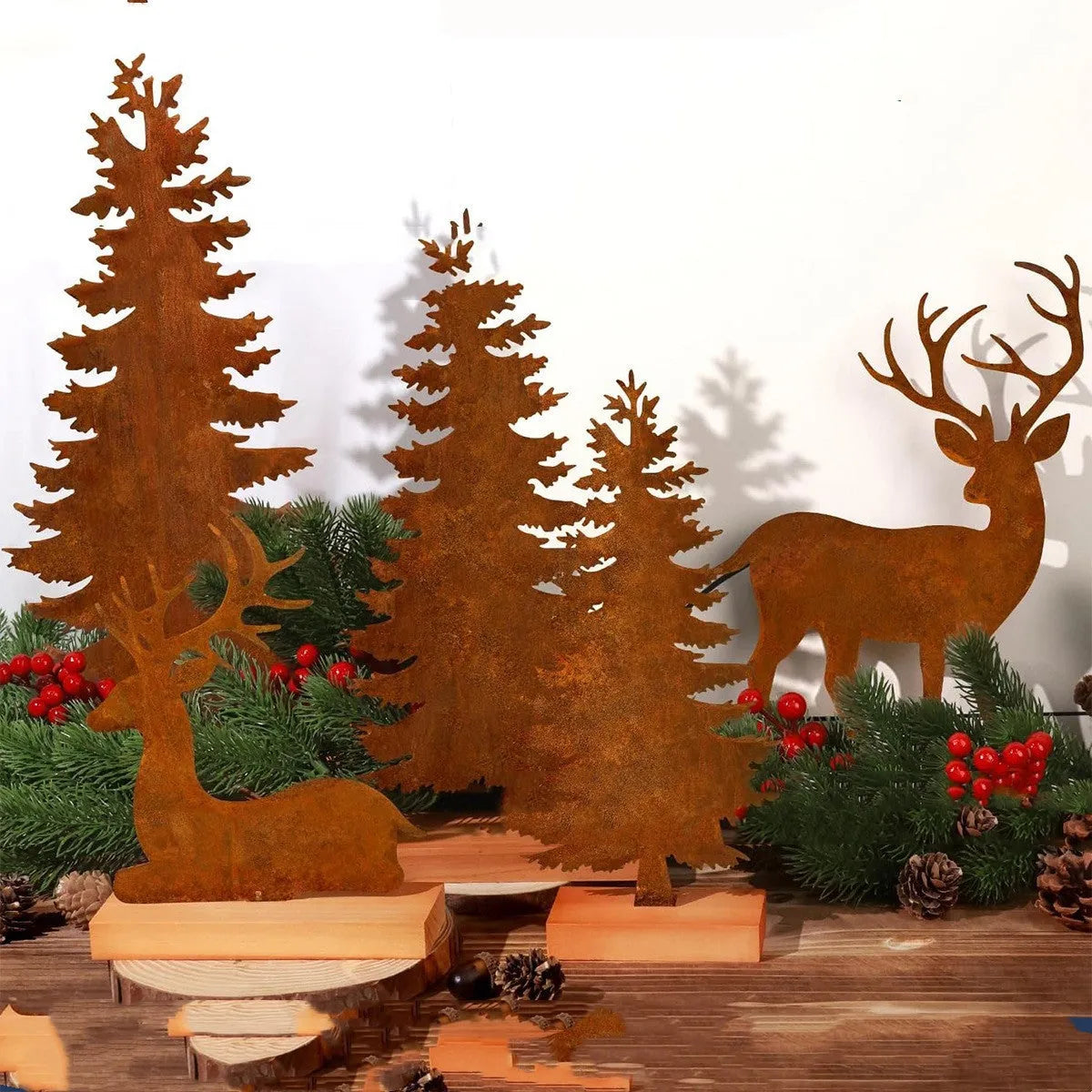 Three rustic metal Christmas tree ornaments shaped like elk with an oxidised iron finish.