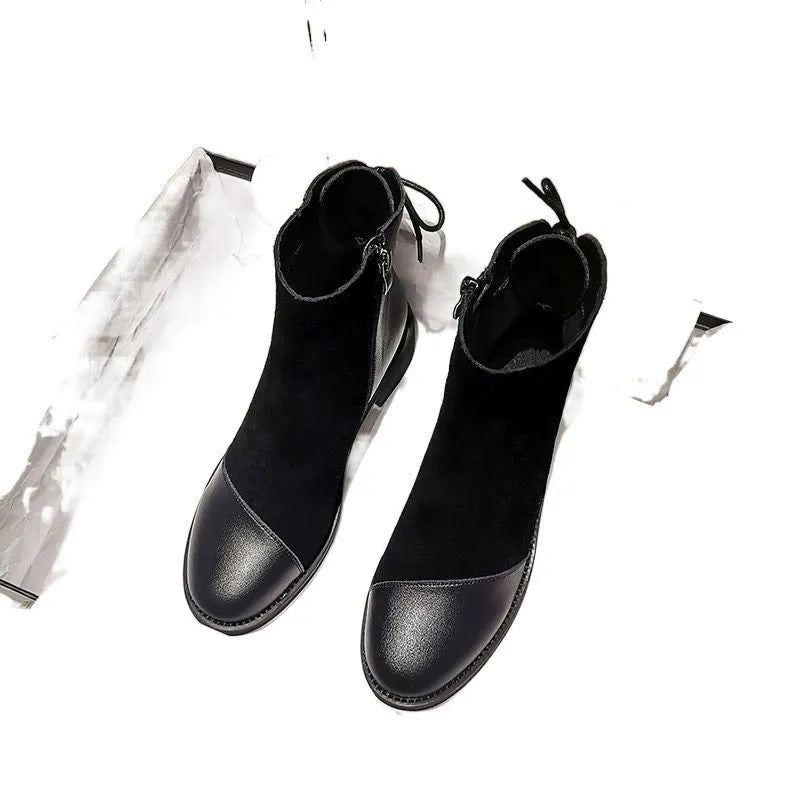 Women's black knee-high Martin boots with side zip and decorative bow detail