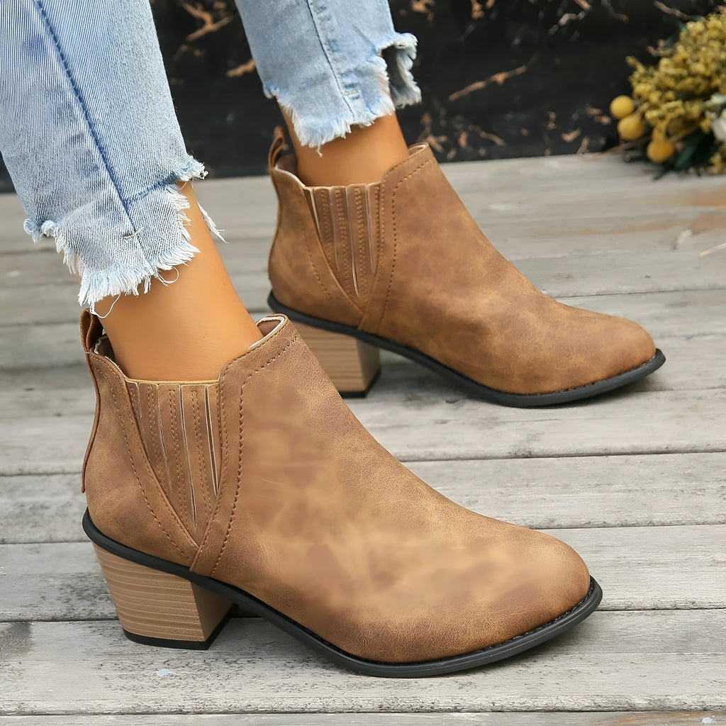 Women's black ankle boots with pointed toes and thick square low heels, slip-on design