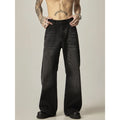 Black loose straight leg retro jeans on a hanger, showing zipper fly detail.