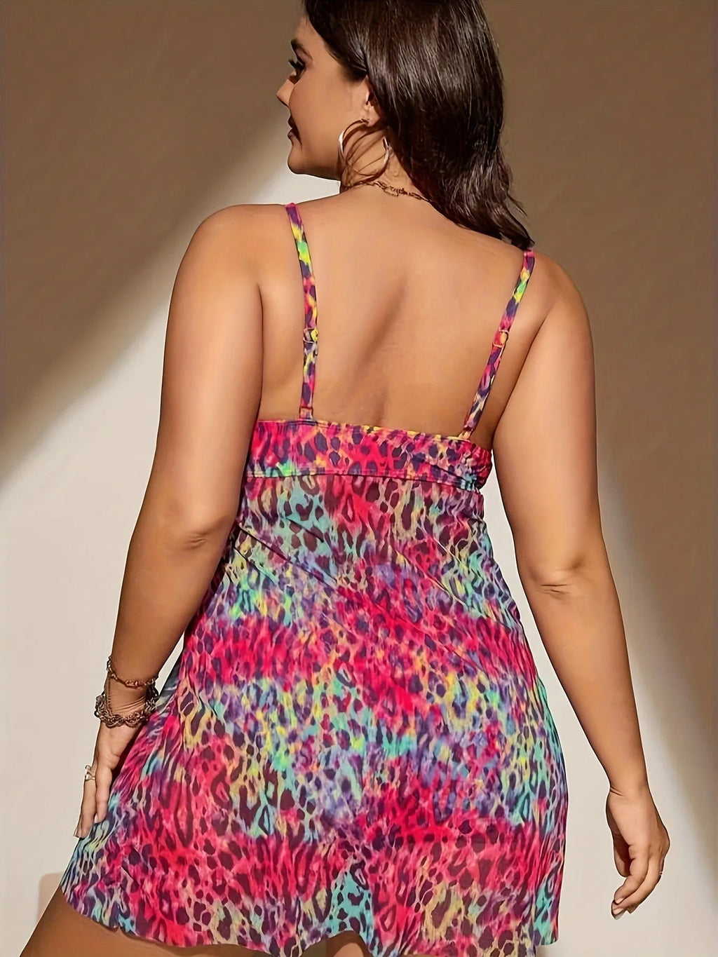 Plus size woman wearing a blue split bikini set, featuring a sleeveless top and shorts, for swimming.