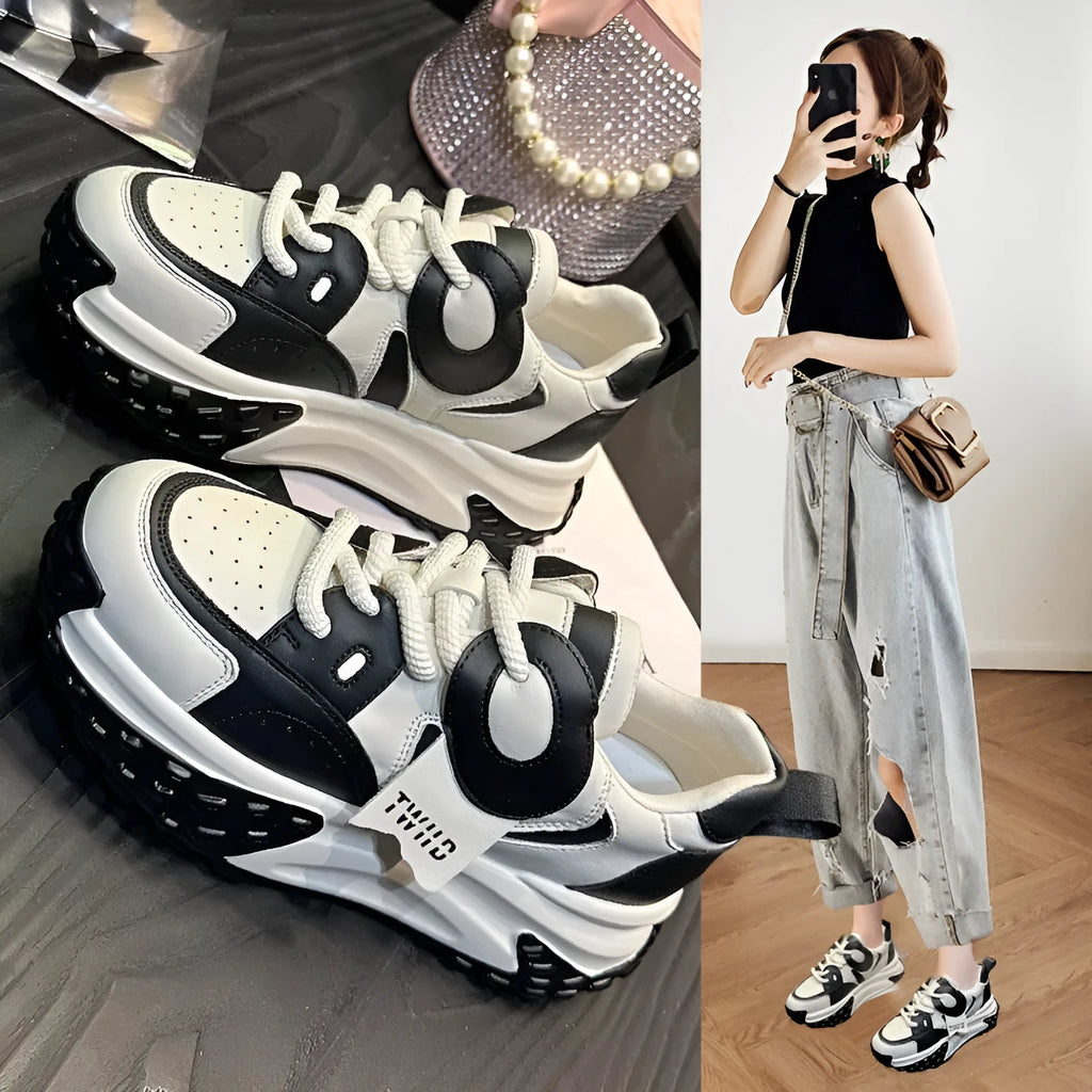 A pair of thick-soled leather casual shoes with a wedge heel and lace-up front fastening.