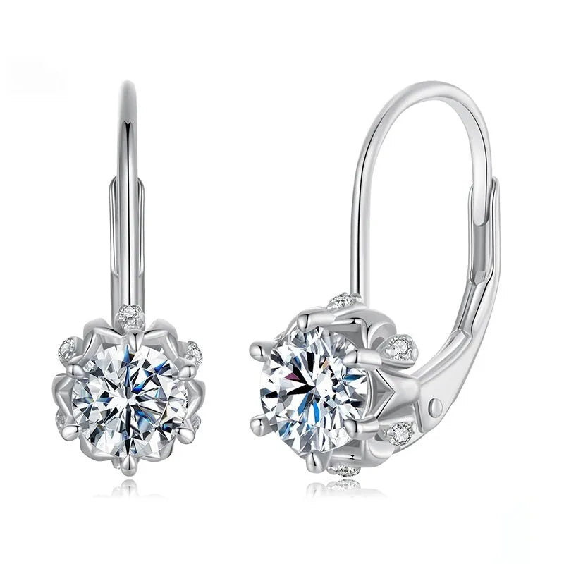 Close-up of a sterling silver flower bud ear clip with a white gold plated finish and a central moissanite stone.