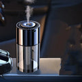 Glass intelligent spray perfume humidifier with USB cable and scent bottle on a desk