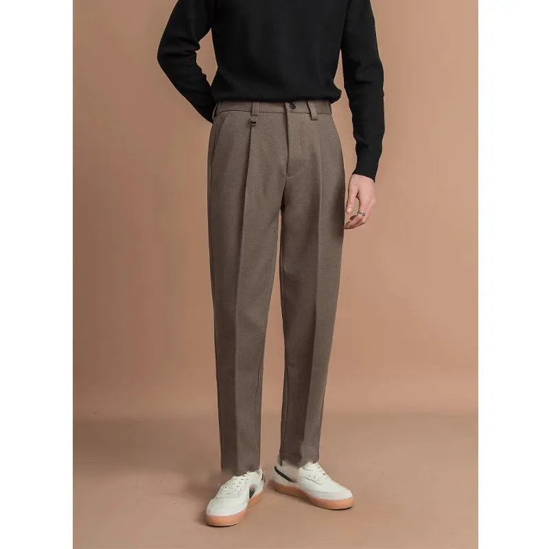 Men's straight-leg polyester trousers in black, shown in a business casual setting.