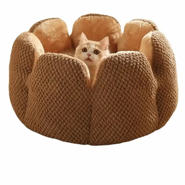 Grey petal-shaped plush kennel bed for cats and dogs on a hardwood floor.
